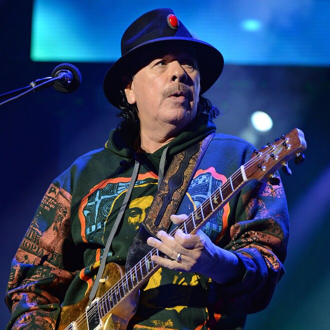 Carlos Santana Hospitalized Ahead of Texas Concert Carlos Santana plays guitar from stage.